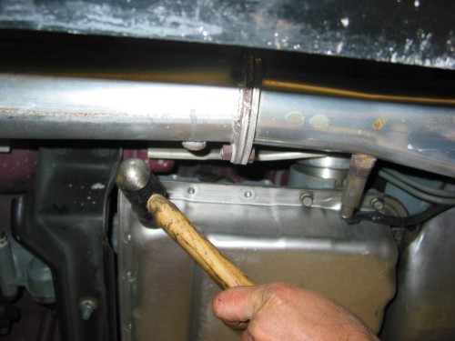 Use a rubber mallet and gently tap the pan.  I used a "real" hammer and if you use a real hammer as well, tap it very gently so as to not dent your pan.  What you are trying to do here is break the seal between the pan, gasket, and transmission.
