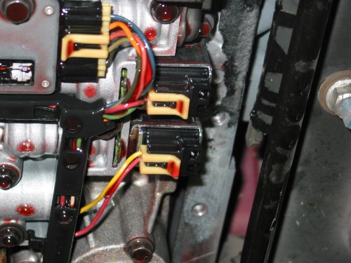 In my case, I'm working on a 4L60E.  On this transmission, these solenoids are delicate and you can damge them if you hit them too hard so be careful to not slip with your scraper and damage any of the internal components in your transmission.