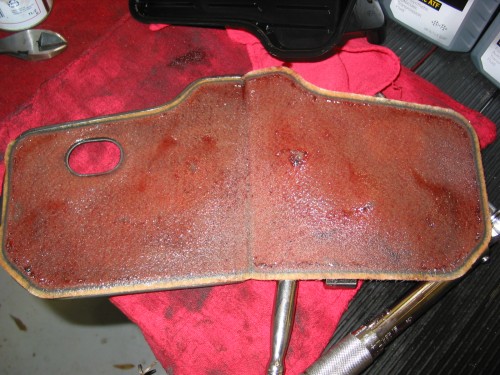 With the filter opened up you can see what has been being filtered.  You can look for converter material and basically "chunks" of stuff.  The dark around the edges is normal and what you see here is pretty typical of a normal wear in the tranny.  If you have any questions or concerns about what you find in your filter, ask a buddy who might know or even take the filter to a tranny shop for them to inspect.  You might be able to find some serious things about to go wrong in your tranny by inspecting this filter and it will be better for you to get it repaired asap than to get stranded someday on the side of the road!