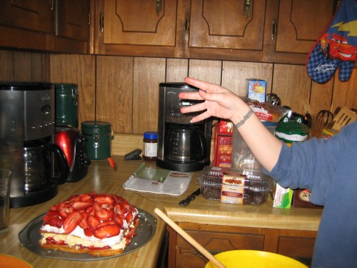 SHEILA THROWING STRAWBERRIES ON HER CAKE