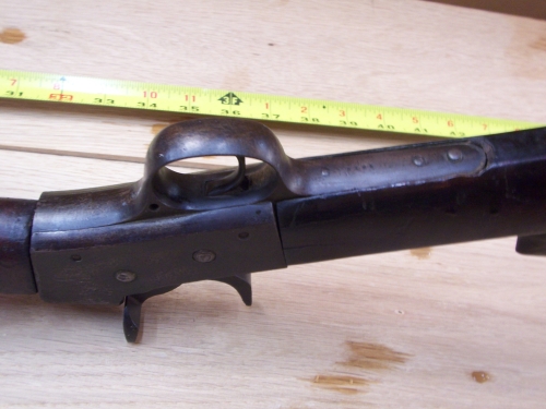 The only markings I can see are these in front of the trigger guard.